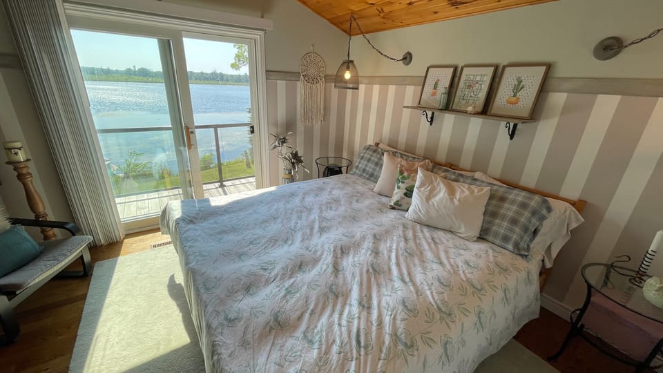 Upstairs king bedroom with the lake filling the window