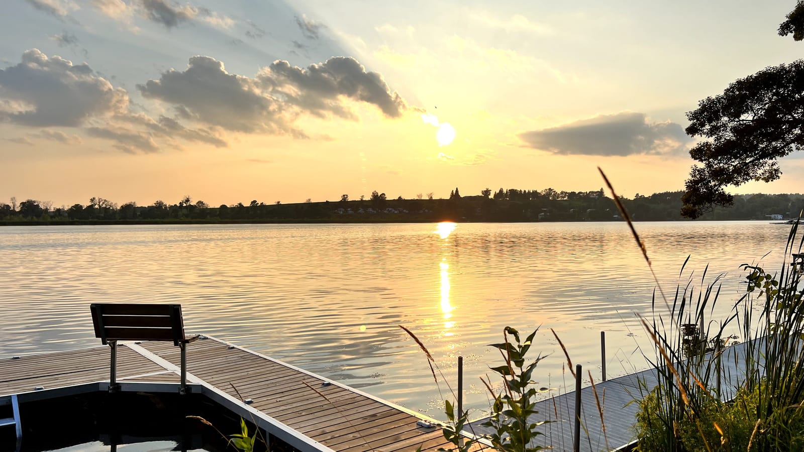 Sunset over Rice Lake from the dock, the sun low over the west shore